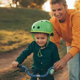 Don’t Let Fear Control Your Motherhood mom helping child to ride a bike