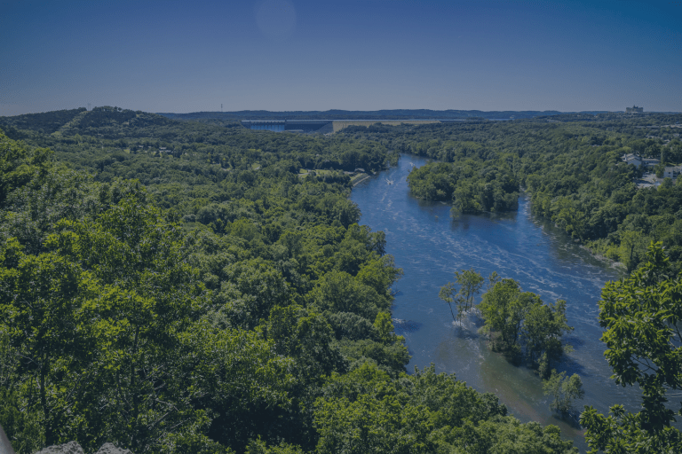 An aerial view of the beautiful tree covered landscape and large blue lake in the area of Branson, Missouri, a location of FamilyLife's Weekend to Remember® marriage retreat event.