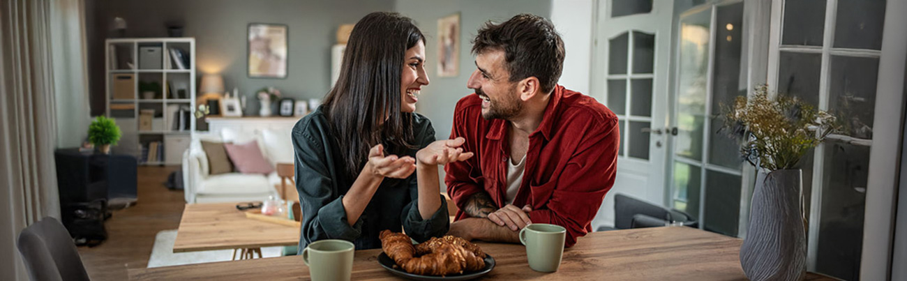 happily married couple having coffee in their home