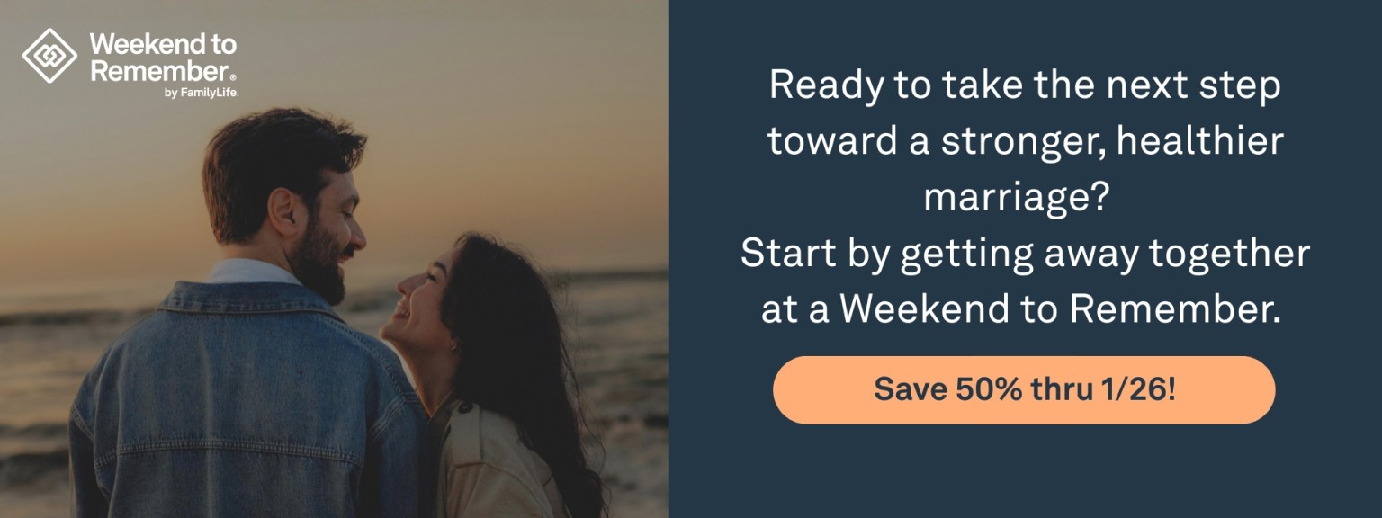 Photo of a married couple standing on a rocky beach at sunset along with a text advertising the Weekend to Remember 50% off sale happening now.