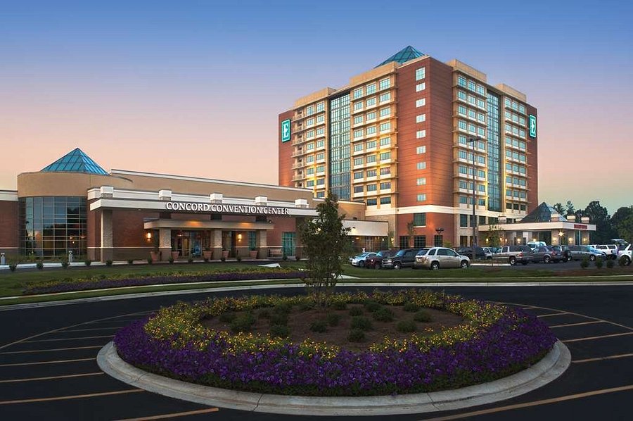 An early morning lighted streetside view looking up at the Embassy Suites Charlotte-Concord Hotel in Charlotte, North Carolina, a location of FamilyLife's Weekend to Remember® marriage retreat event