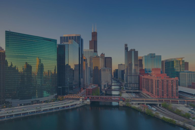 An early morning, sunlit classic view of Chicago's reflective glass-covered skyscrapers that line both sides of the Chicago River, connected by numerous iconic, movable bridges in downtown Chicago (Oak Brook), Illinois, a location of FamilyLife's Weekend to Remember® marriage retreat event.
