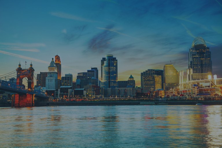 An early morning, beautifully reflective waterside view of this downtown city skyline, which sits on the banks of the Ohio River in Cincinnati, Ohio, a location of FamilyLife's Weekend to Remember® marriage retreat event.
