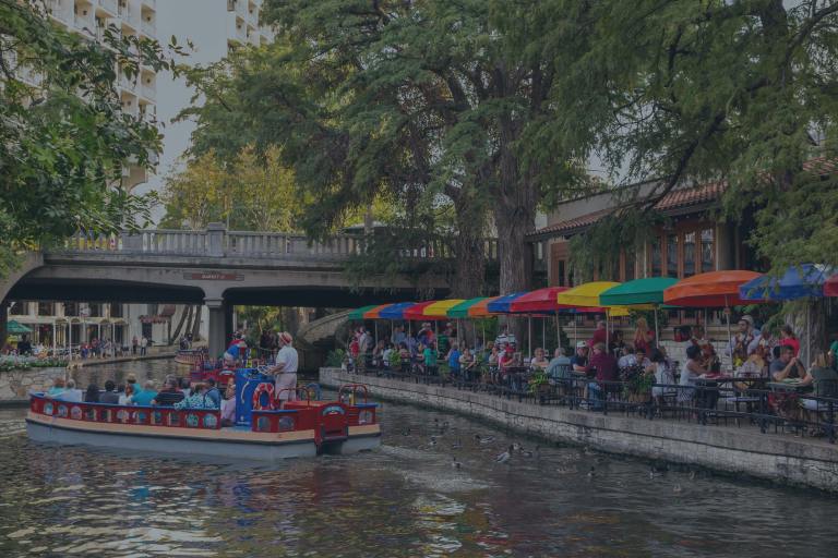 A downtown waterside cafe and water taxi in San Antonio, Texas, one of the locations for a Weekend to Remember® marriage retreat.