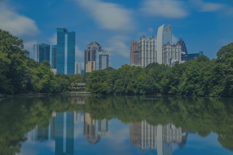 Lakeside view looking up toward the skyline of tall buildings that make up the downtown area of Atlanta, Georgia, a location of FamilyLife's Weekend to Remember® marriage retreat event.