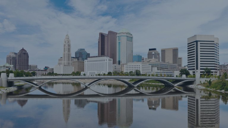 A view of the downtown skyline starting at the city's mirrored reflection displayed on top of the Scioto River, and looking up toward downtown Columbus, Ohio, a location of FamilyLife's Weekend to Remember® marriage retreat event.